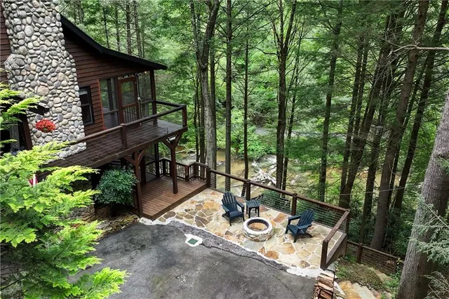 a porch with wooden floor in front of it