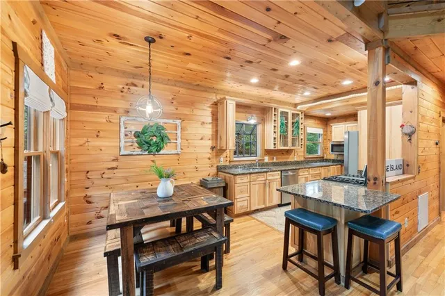 a kitchen with a sink and large windows