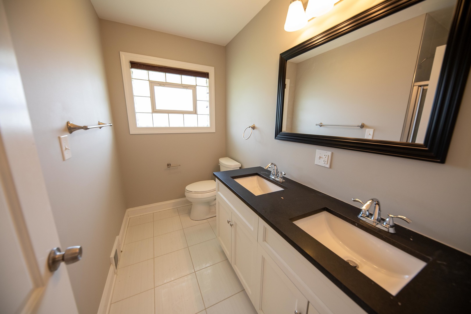1722 East Aztec Lane Mount Prospect, IL 60056 - Photo 12 of 18 a bathroom with a granite countertop sink a mirror and a toilet