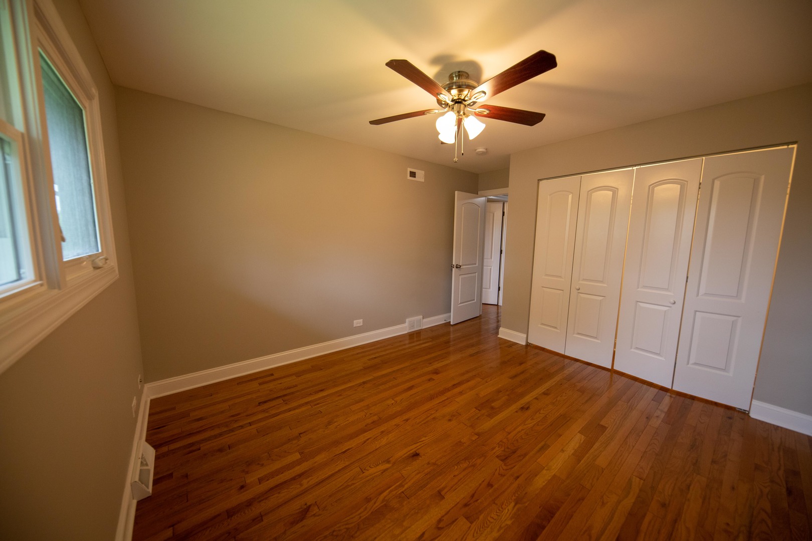 1722 East Aztec Lane Mount Prospect, IL 60056 - Photo 15 of 18 a view of empty room with wooden floor and fan