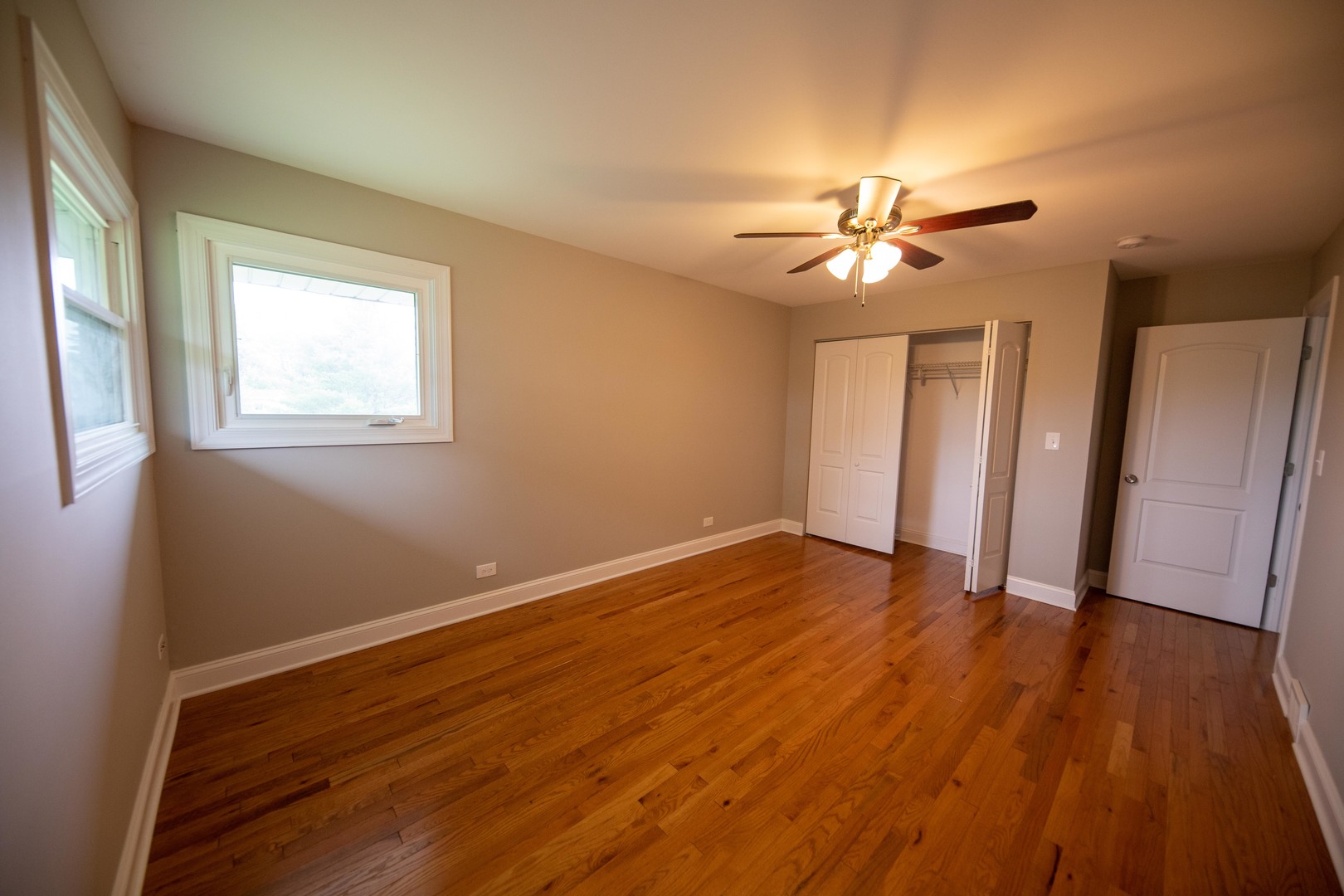 1722 East Aztec Lane Mount Prospect, IL 60056 - Photo 16 of 18 a view of empty room with wooden floor and fan