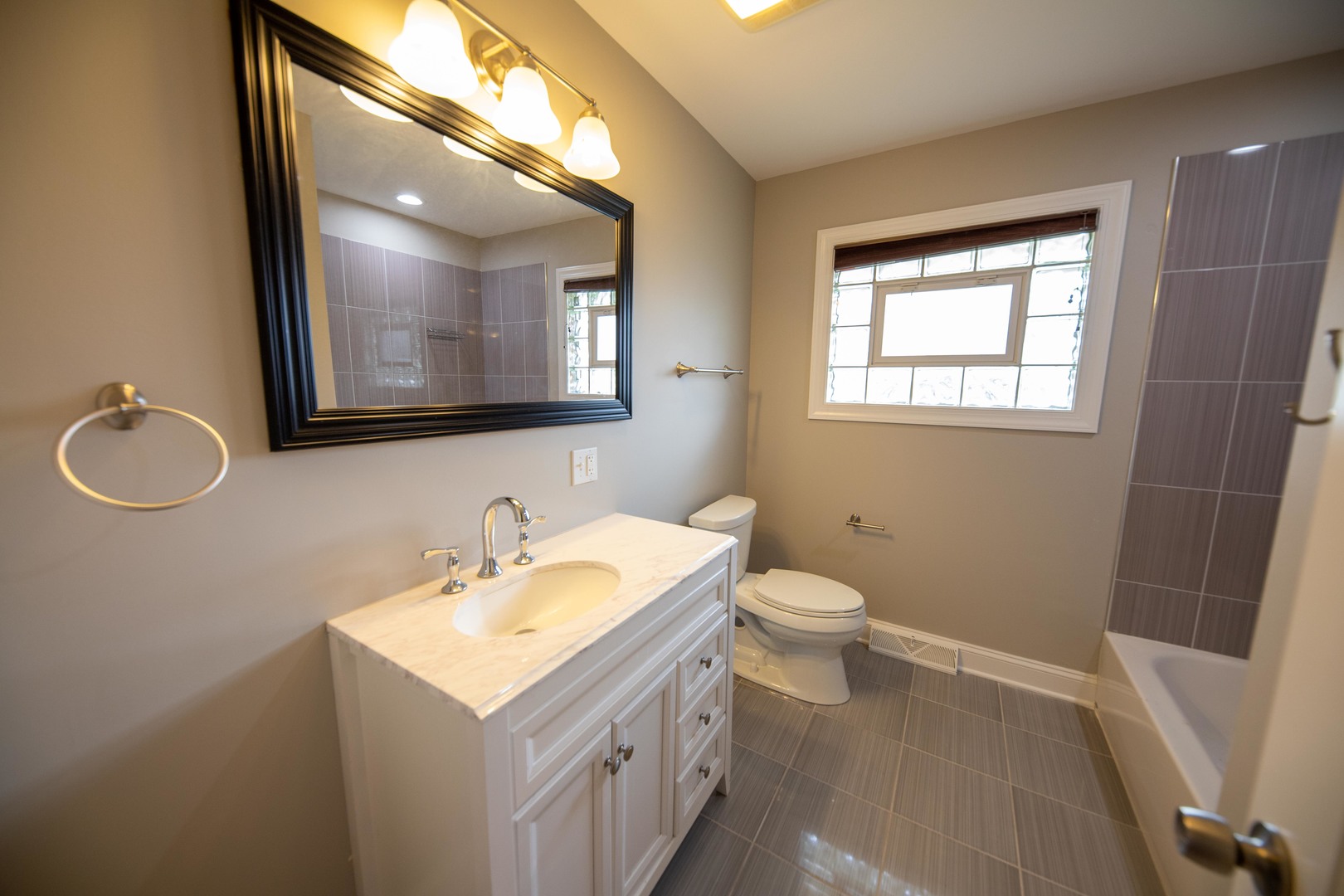 1722 East Aztec Lane Mount Prospect, IL 60056 - Photo 17 of 18 a bathroom with a toilet sink and mirror