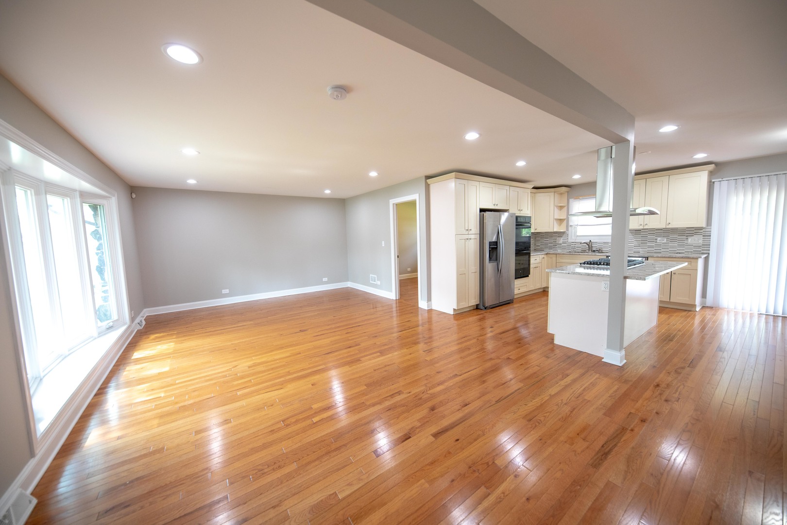 1722 East Aztec Lane Mount Prospect, IL 60056 - Photo 3 of 18 a view of a kitchen with a refrigerator and wooden floor