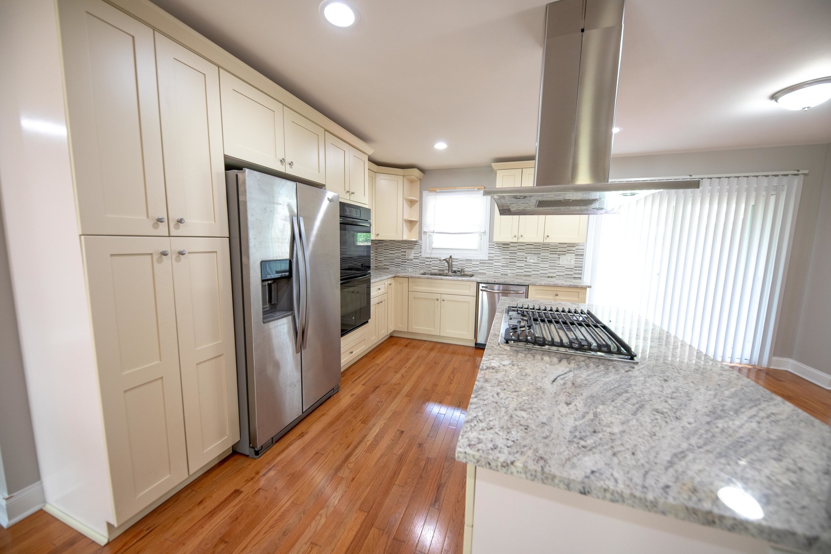 1722 East Aztec Lane Mount Prospect, IL 60056 - Photo 4 of 18 a kitchen with stainless steel appliances granite countertop a refrigerator and a stove