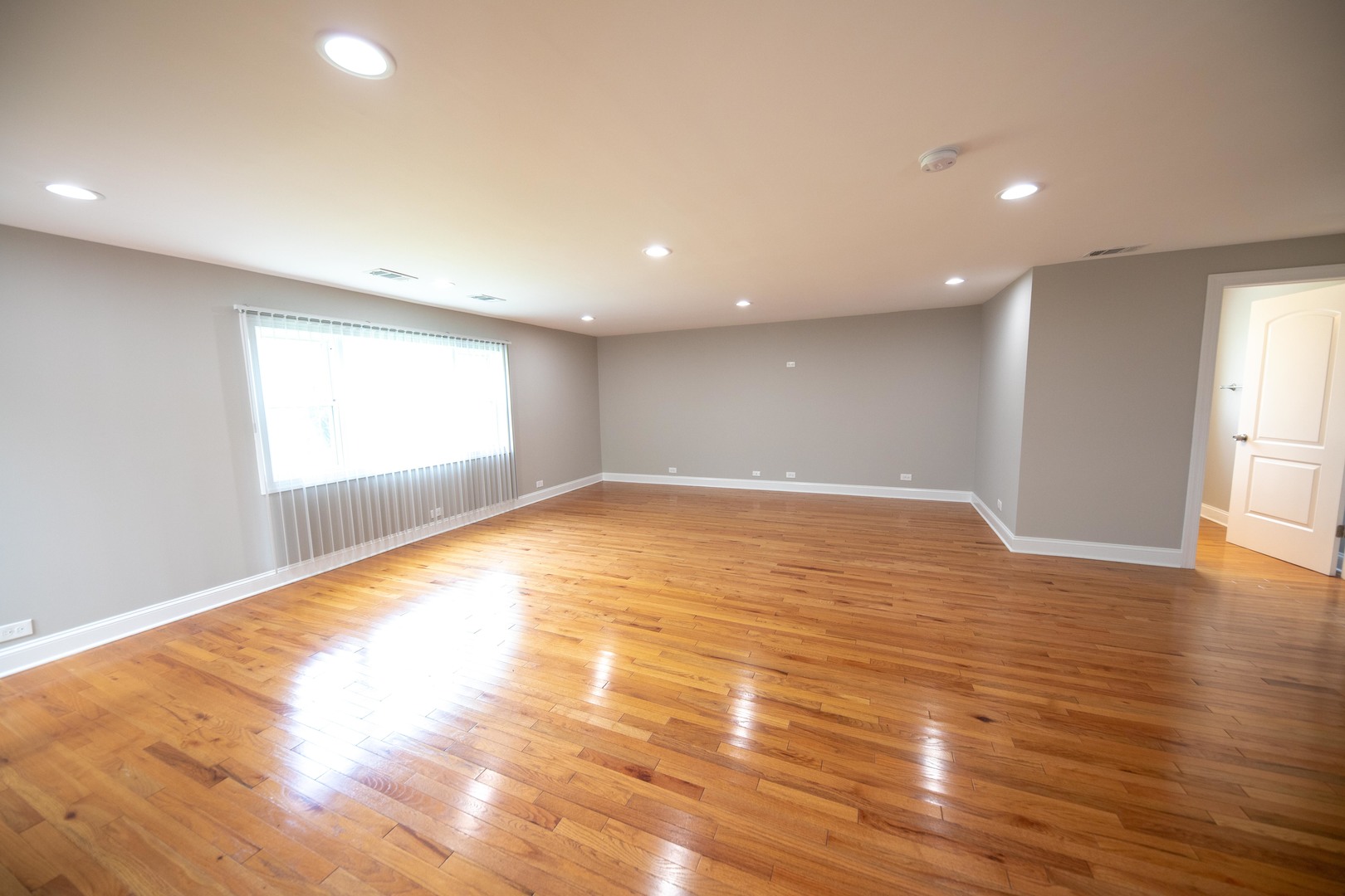 1722 East Aztec Lane Mount Prospect, IL 60056 - Photo 8 of 18 a view of empty room with wooden floor and fan