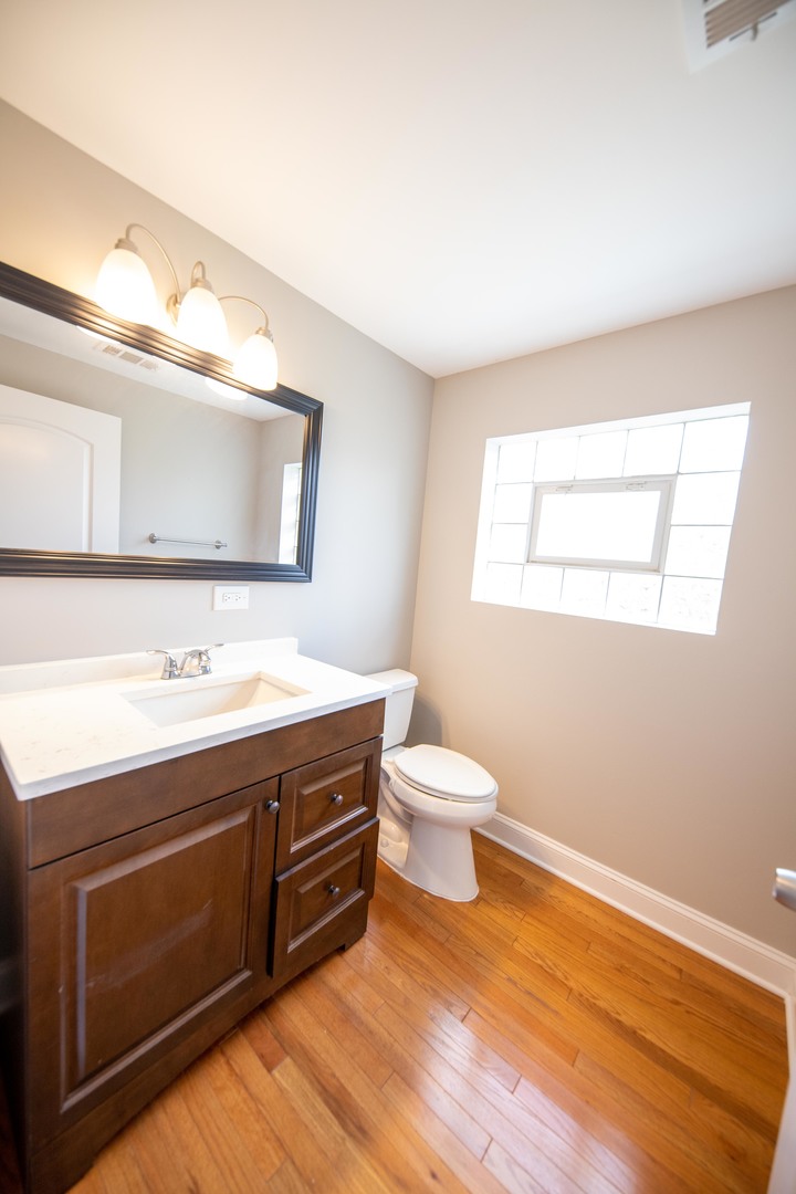 1722 East Aztec Lane Mount Prospect, IL 60056 - Photo 9 of 18 a bathroom with a sink and a toilet
