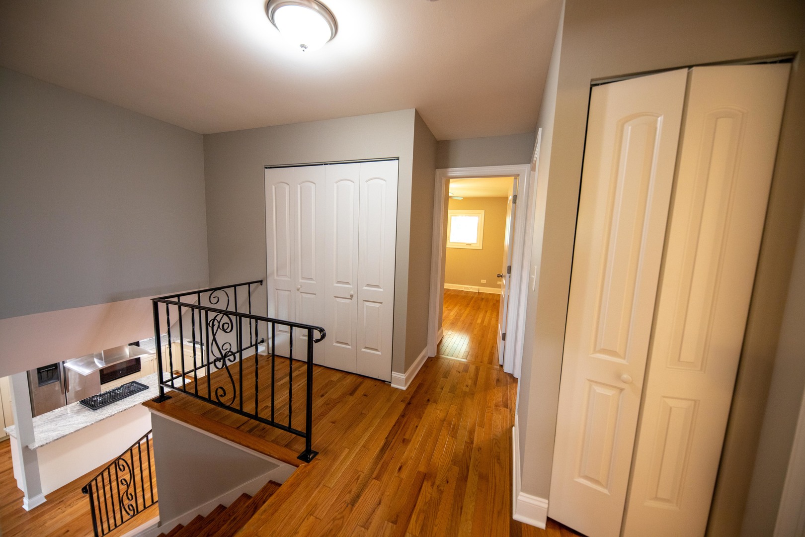 1722 East Aztec Lane Mount Prospect, IL 60056 - Photo 10 of 18 a view of a hallway with wooden floor and staircase