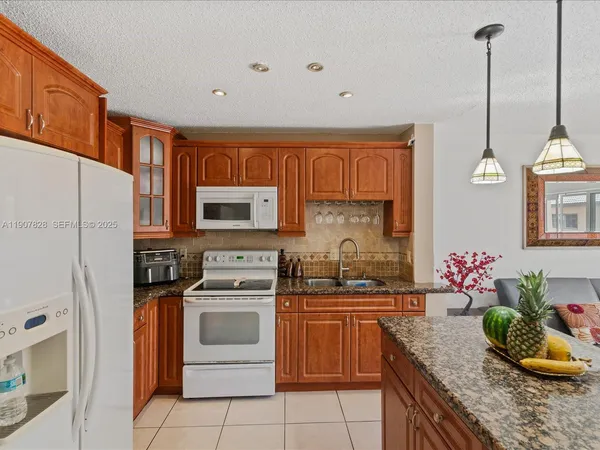 a kitchen with a sink stove and refrigerator