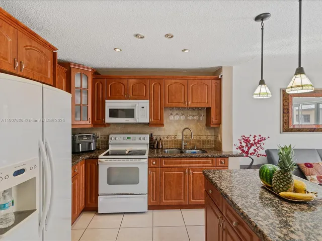 a kitchen with a sink stove and refrigerator