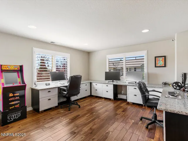 a view of workspace with wooden floor and windows