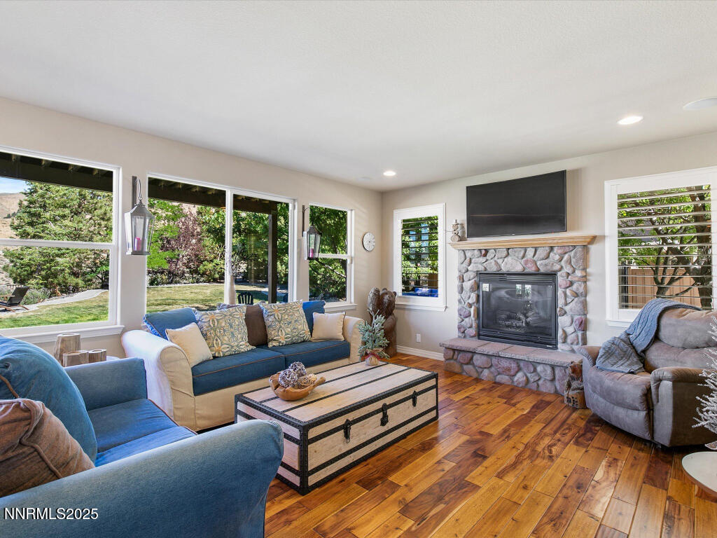 7284 Glenmore Court Reno, NV 89523 - Photo 2 of 28 a living room with furniture a flat screen tv and a fireplace