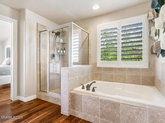 a bathroom with a bathtub and a shower
