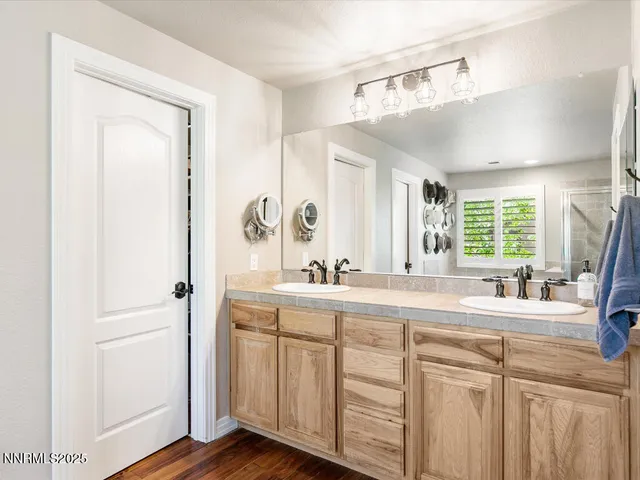 a bathroom with a double vanity sink and a mirror