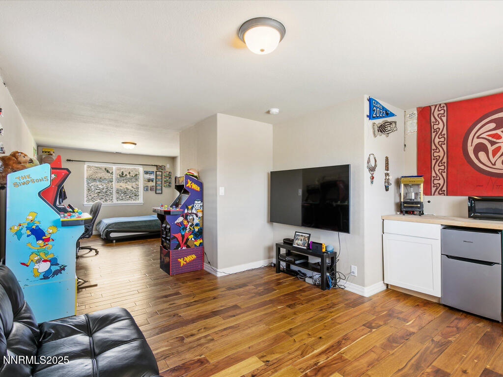 7284 Glenmore Court Reno, NV 89523 - Photo 7 of 28 a living room with furniture and a flat screen tv