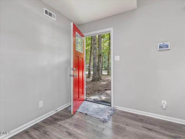 a view of entryway and hall with wooden floor