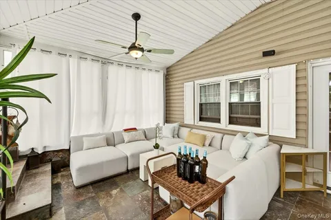 a living room with furniture a chandelier and a window