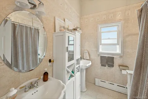 a bathroom with a sink a window and a mirror