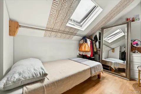 a bedroom with a bed next to a window with outer view