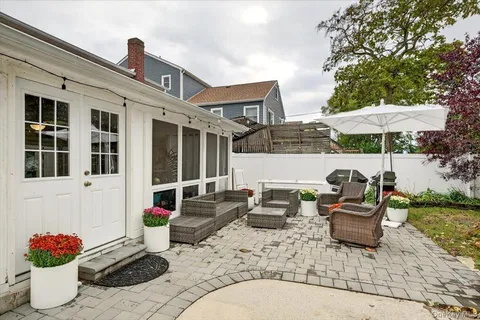 a view of a patio with couches chairs and potted plants