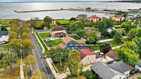 an aerial view of multiple houses with yard