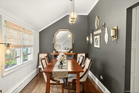 a view of a dining room with furniture and a window