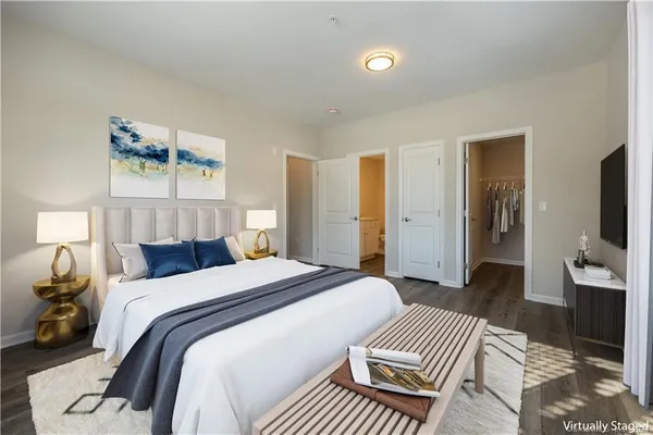 a bedroom with a bed and a flat screen tv