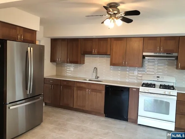 a kitchen that has a sink and a stove