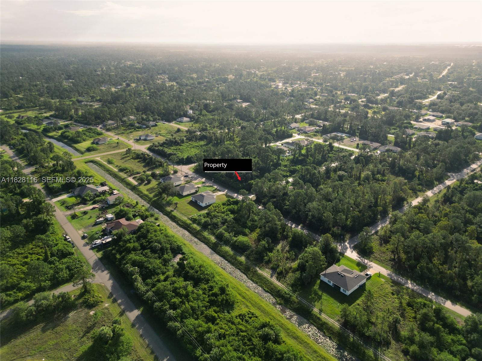 953 Lytle Street East Lehigh Acres, FL 33974 - Photo 11 of 12 an aerial view of residential building with green space