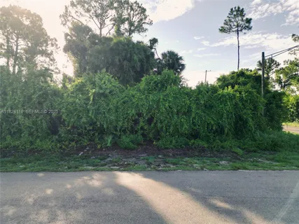 an aerial view of residential building with green space