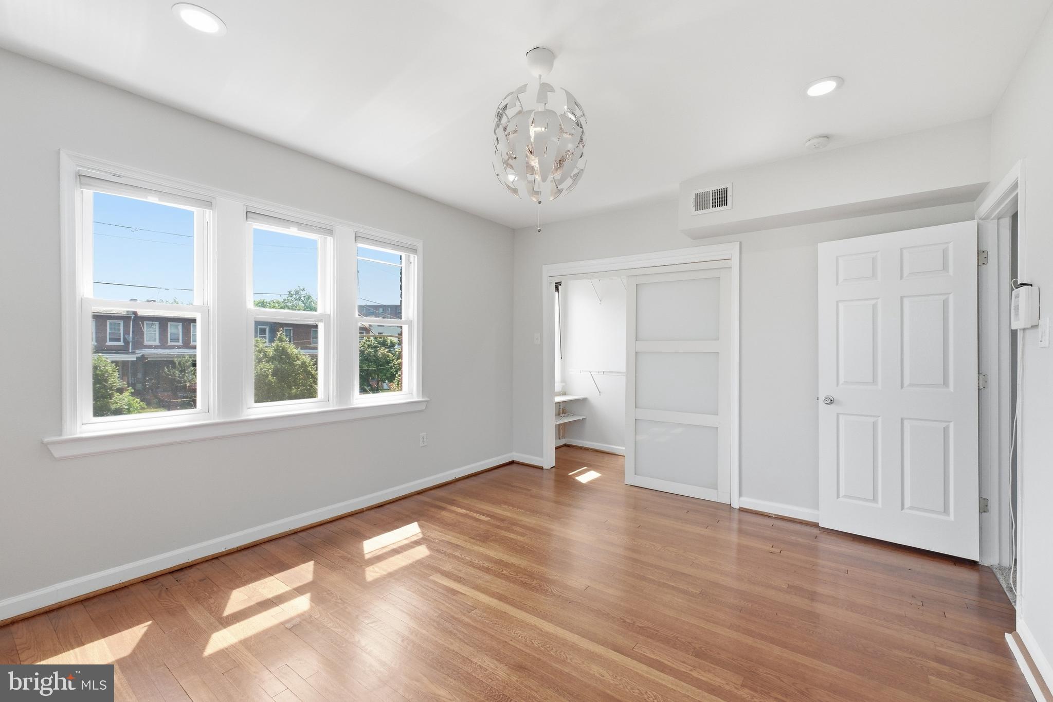 2712 6th Street Northeast Washington, DC 20017 - Photo 15 of 24 a view of an empty room with wooden floor and a window