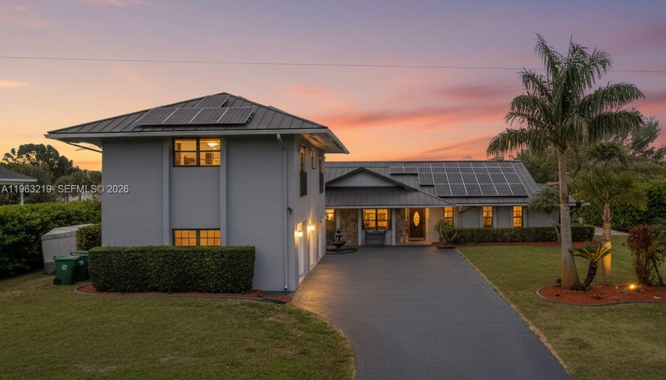 14651 Southwest 16th Street Davie, FL 33325 - Photo 12 of 52 a front view of a house with a yard and garage