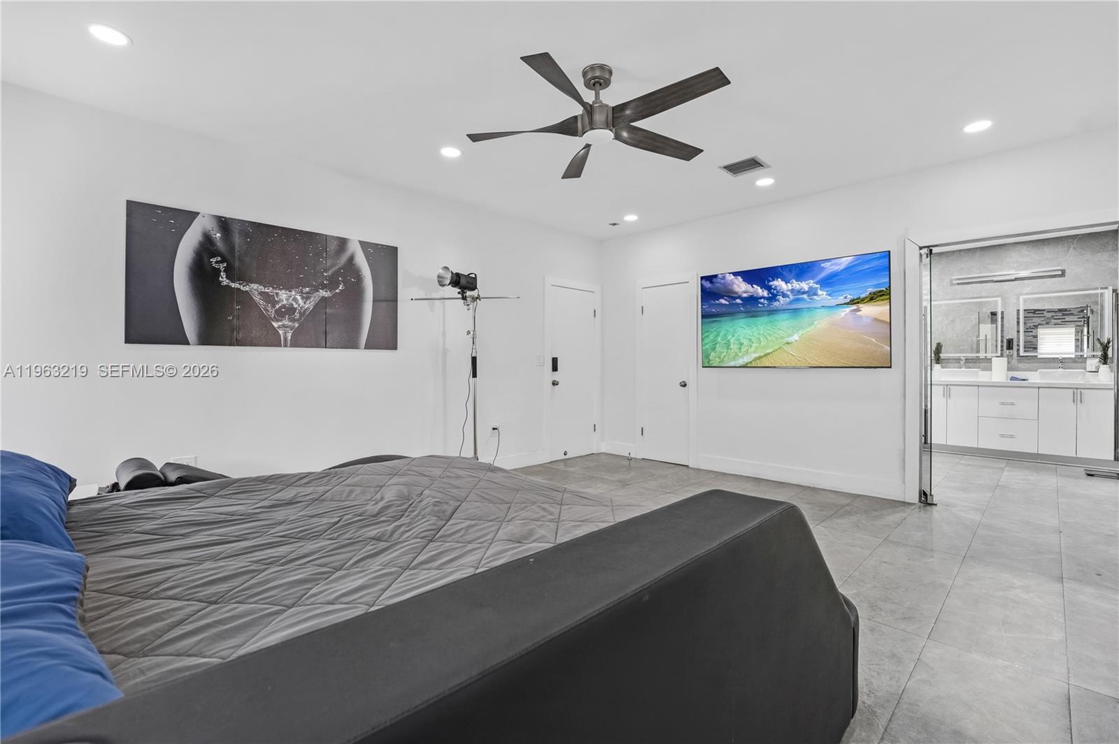 14651 Southwest 16th Street Davie, FL 33325 - Photo 23 of 52 a bedroom with a bed and a painting on the wall