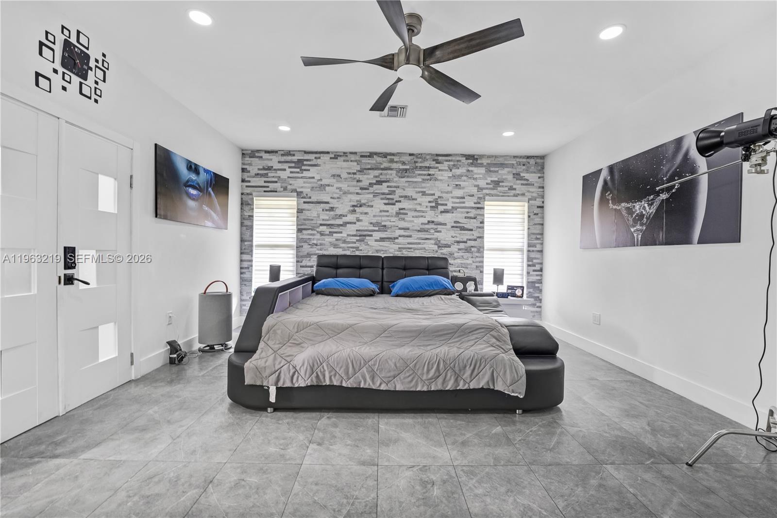 14651 Southwest 16th Street Davie, FL 33325 - Photo 24 of 52 a bedroom with a bed and a flat screen tv