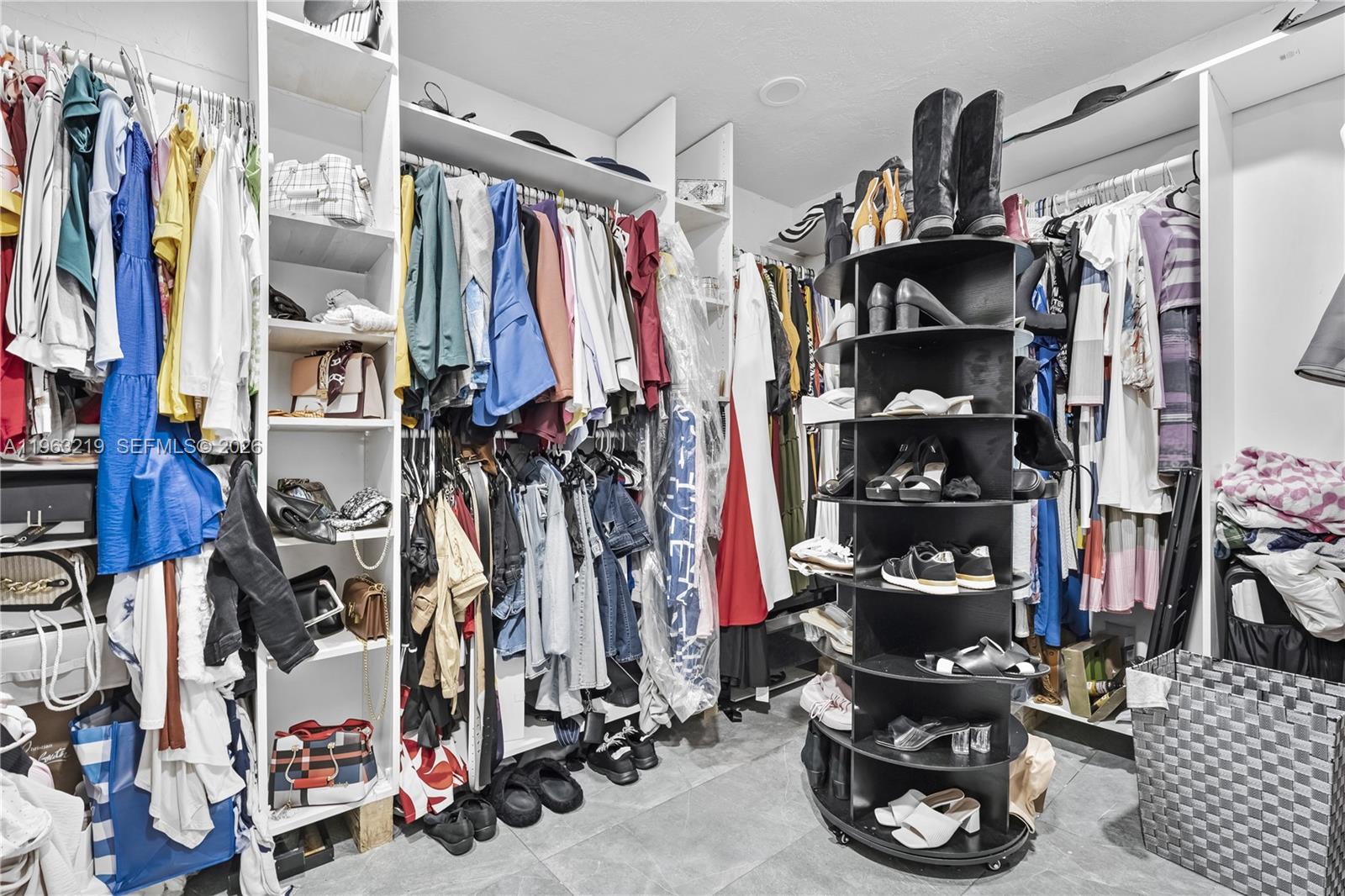 14651 Southwest 16th Street Davie, FL 33325 - Photo 25 of 52 a view of walk in closet with clothes and shoes