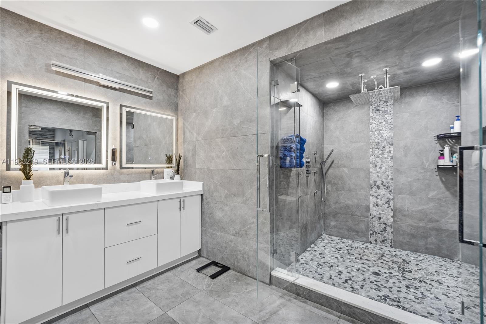 14651 Southwest 16th Street Davie, FL 33325 - Photo 29 of 52 a bathroom with a shower sink and mirror