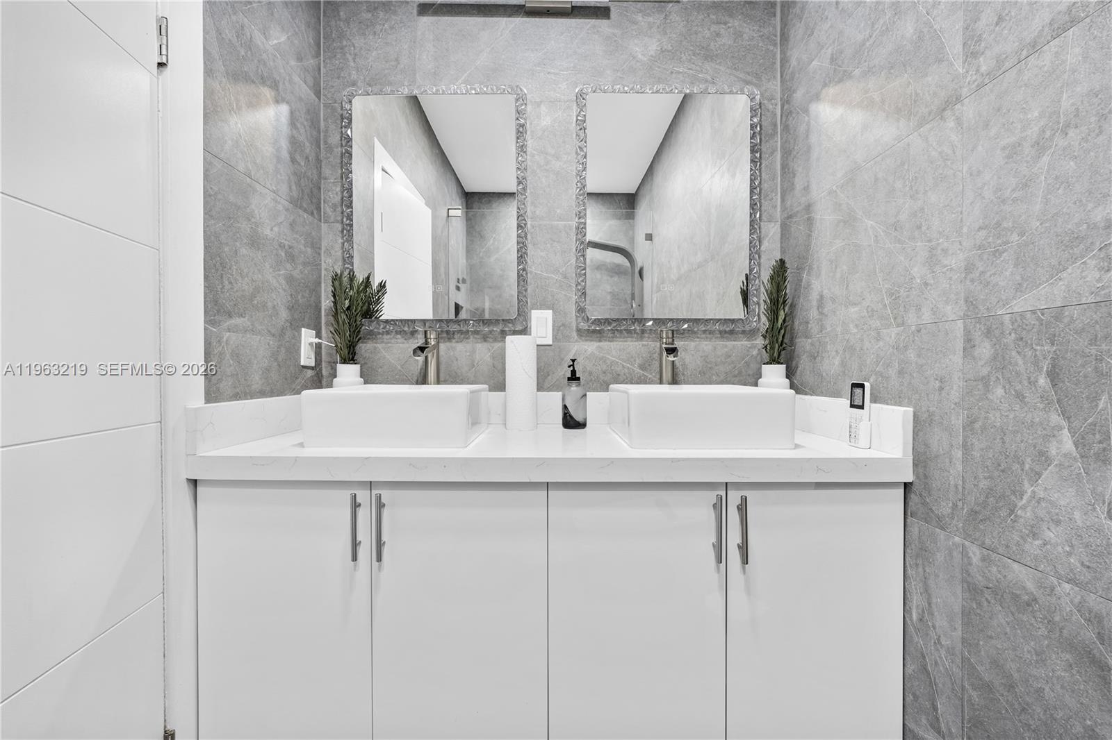 14651 Southwest 16th Street Davie, FL 33325 - Photo 32 of 52 a bathroom with double sink and two mirror