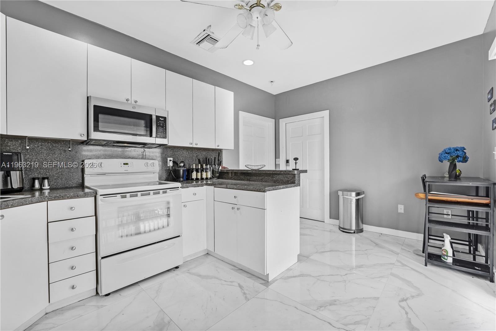 14651 Southwest 16th Street Davie, FL 33325 - Photo 36 of 52 a kitchen with cabinets appliances cabinets and furniture