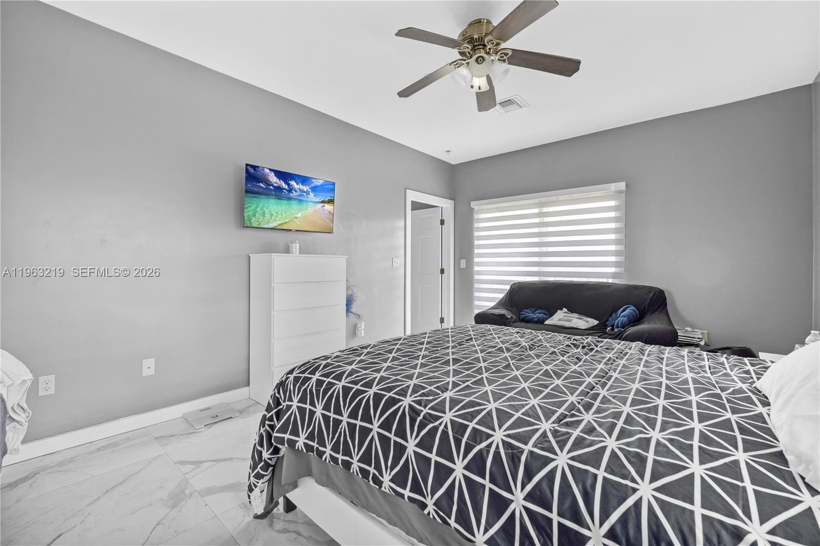 14651 Southwest 16th Street Davie, FL 33325 - Photo 41 of 52 a bedroom with a bed and a chandelier