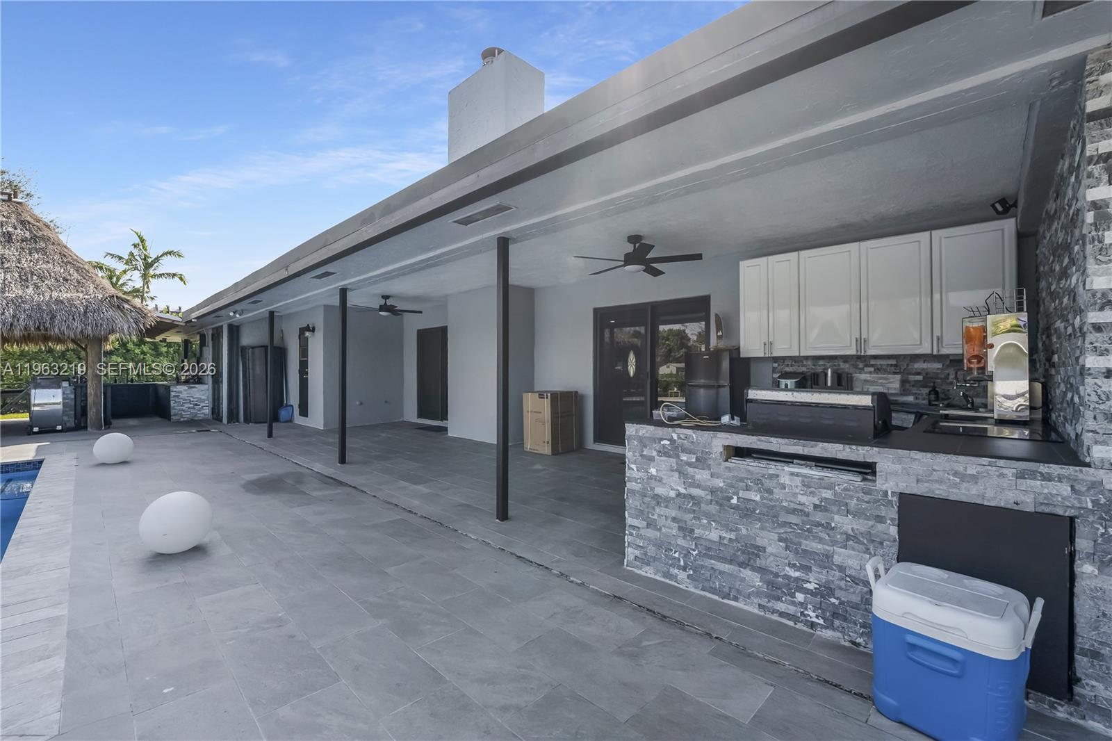 14651 Southwest 16th Street Davie, FL 33325 - Photo 44 of 52 a view of living room kitchen with stainless steel appliances granite countertop furniture and a fireplace