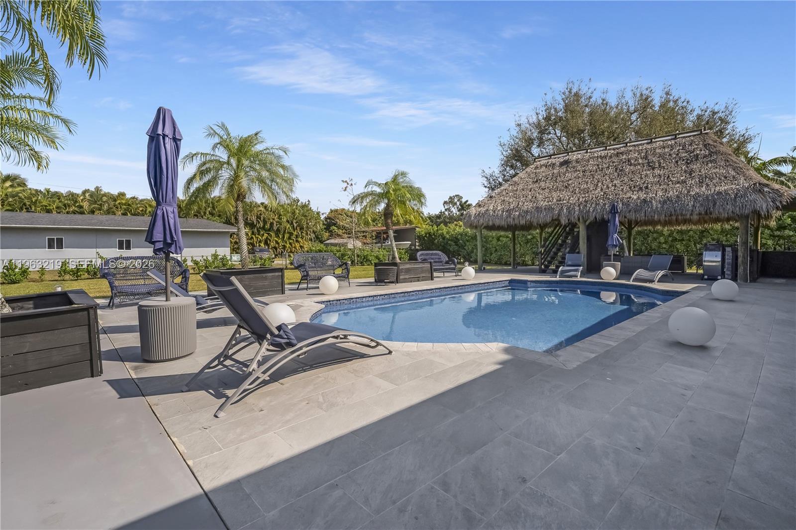 14651 Southwest 16th Street Davie, FL 33325 - Photo 45 of 52 a swimming pool with outdoor seating and yard