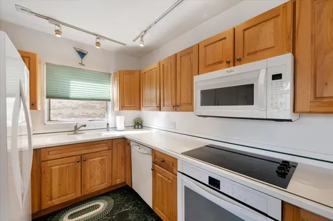 a kitchen with a sink cabinets and oven