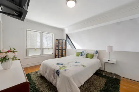 a bedroom with a bed and a potted plant