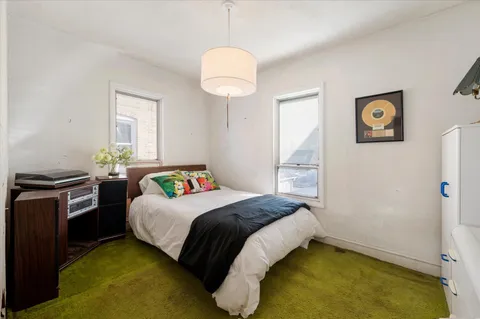 a bedroom with a bed and a chandelier