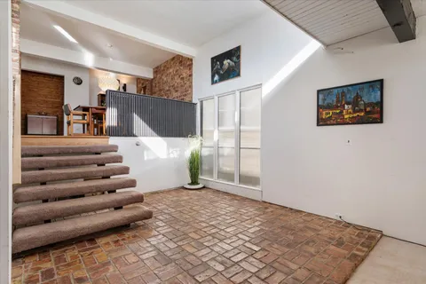 a view of a livingroom with furniture and staircase