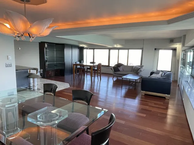a dining room with furniture window and wooden floor