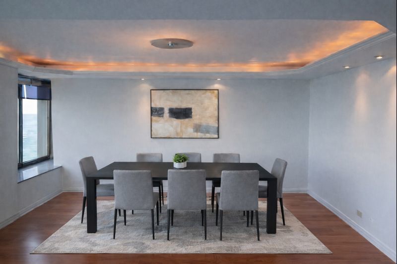 175 East Delaware Place, Unit 8604 Chicago, IL 60611 - Photo 11 of 28 a view of a dining room with furniture and wooden floor