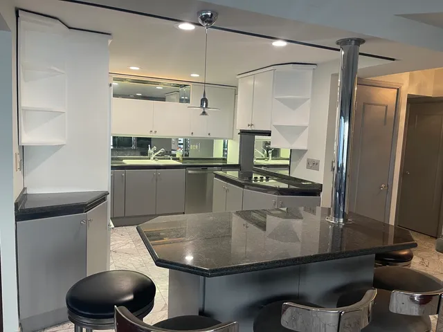 a kitchen with a sink stainless steel appliances and cabinets