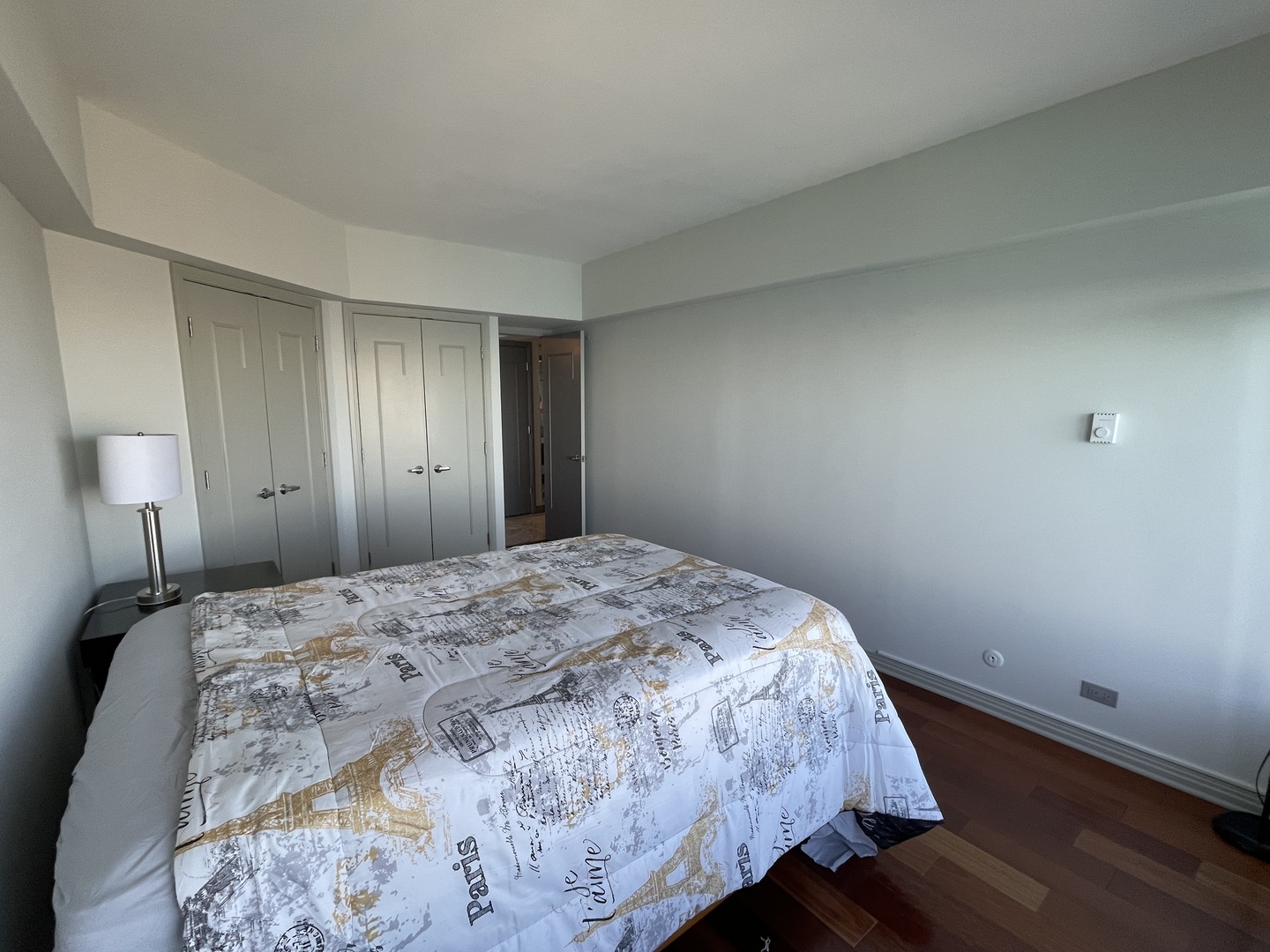 175 East Delaware Place, Unit 8604 Chicago, IL 60611 - Photo 28 of 31 a bedroom with a bed and wooden floor