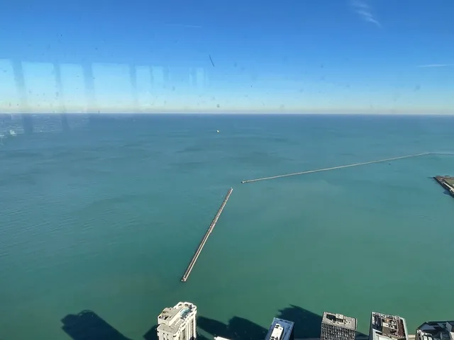 a view of a room with an empty space and a window