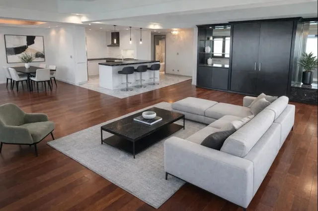 a living room with furniture rug and wooden floor